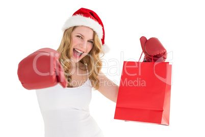 Festive blonde with boxing gloves and shopping bag