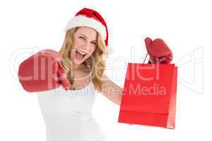 Festive blonde with boxing gloves and shopping bag