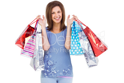 Portrait of cute young woman with shopping bags