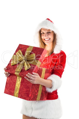 Festive pretty brunette opening a gift