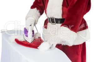 Father Christmas is ironing his hat