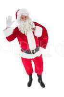 Santa holding a sack and waving