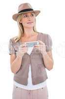 Happy blonde in trilby holding phone