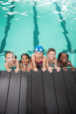 Cute swimming class listening to coach