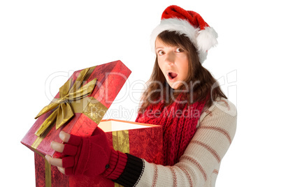 Young woman opening a glowing christmas gift