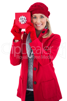 Festive blonde holding red gift