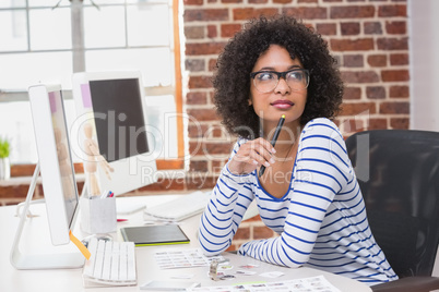 Thoughtful female photo editor in office