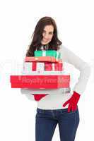 Pretty brunette posing and holding pile of gifts
