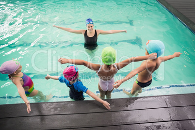 Cute swimming class watching the coach