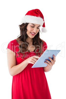 Festive brunette using her tablet pc