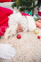 Exhausted santa sleeping on the rug