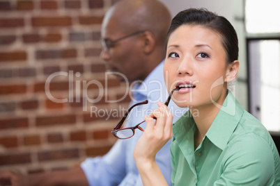 Thoughtful young businesswoman in office