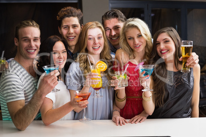 Happy friends having a drink together