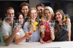 Happy friends having a drink together