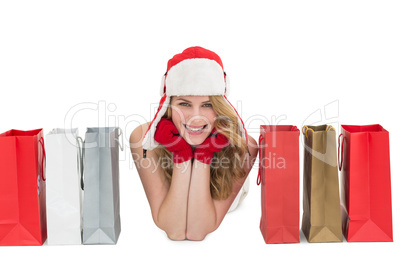 Smiling woman lying between shopping bags