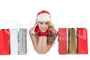 Smiling woman lying between shopping bags