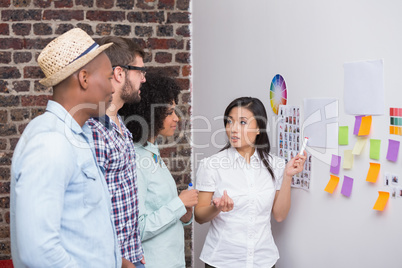 Team looking at sticky notes on wall