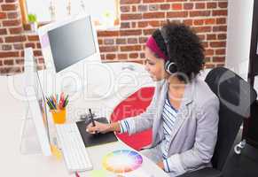 Female photo editor using digitizer in office
