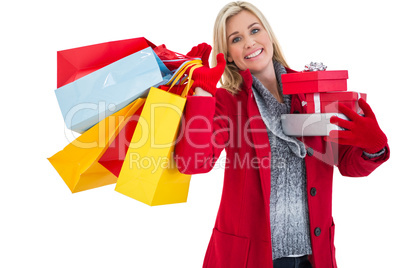 Festive blonde holding many gifts