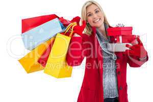 Festive blonde holding many gifts