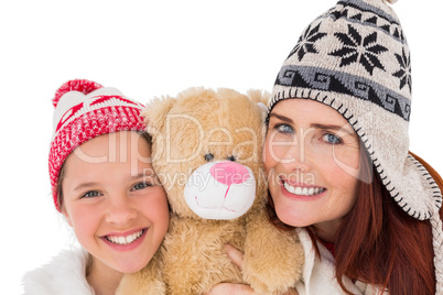 Mother and daughter holding teddy bear