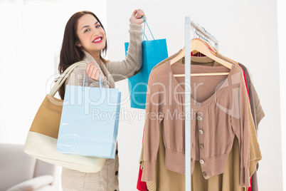 Pretty brunette holding shopping bags