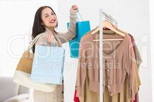 Pretty brunette holding shopping bags