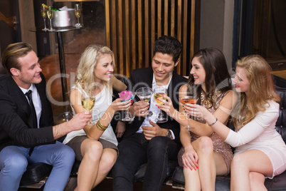 Happy friends having a drink together