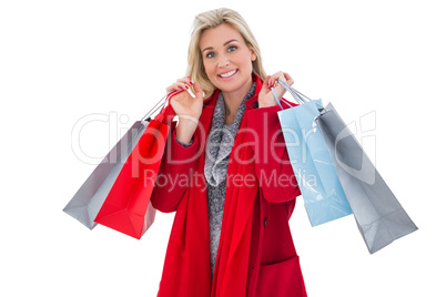 Blonde in winter clothes holding shopping bags Blonde in winter clothes holding shopping bags