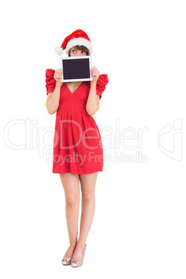 Festive brunette holding a tablet pc