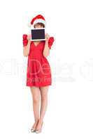 Festive brunette holding a tablet pc