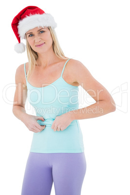 Festive fit blonde pinching her stomach