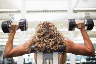 Close up of a man exercising with dumbbells