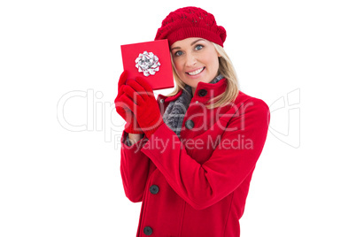 Festive blonde holding red gift