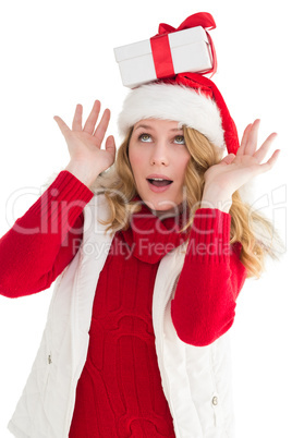 Smiling santa young woman with gift on her head