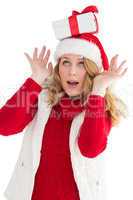 Smiling santa young woman with gift on her head