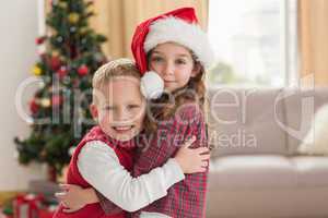 Festive siblings smiling at camera