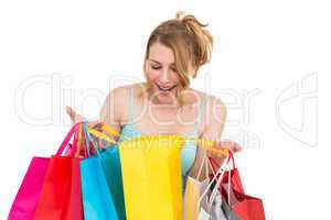 Excited woman looking at many shopping bags
