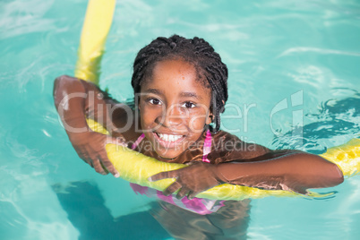 Cute little girl swimming in the pool