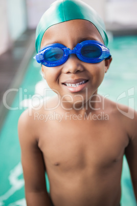 Cute little boy smiling at the pool