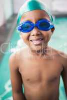 Cute little boy smiling at the pool