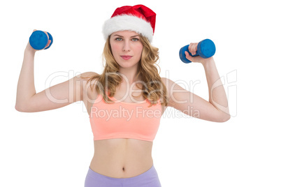 Festive fit blonde holding dumbbells