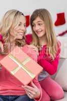 Little girl giving her mother a christmas gift