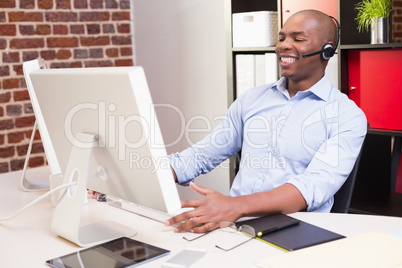 Cheerful businessman using computer in office