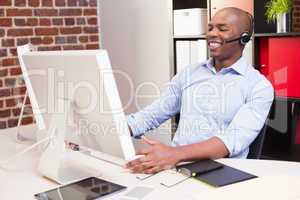 Cheerful businessman using computer in office