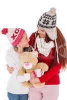 Mother and daughter holding teddy bear