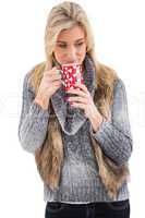 Woman in winter clothes holding a mug