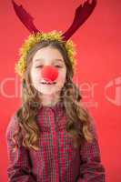 Festive little girl wearing red nose