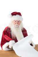 Santa writes something with a feather