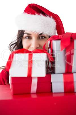 Festive brunette holding stack of gifts